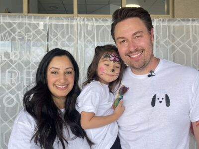 Rashi Wiese (L) and Eric Wiese (R) pose with their daughter, Asara Wiese (C), 3-and-a-half at the WRARE Foundation's "Paws N' Flow" dog adoption event at YogaSix in Stevenson Ranch, Saturday, Aug. 23, 2025. Kamryn Martell/The Signal