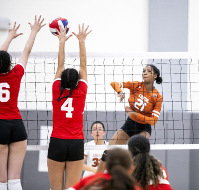 Castaic opposite hitter Arielle Greene (21) hits the ball over the net against Taft opposite hitter Gabriela Ulikhanyan (4) and middle blocker Chloe Fields (6) during the third set of Wednesday's game at Castaic High School on Aug. 27, 2025. Habeba Mostafa/ The Signal