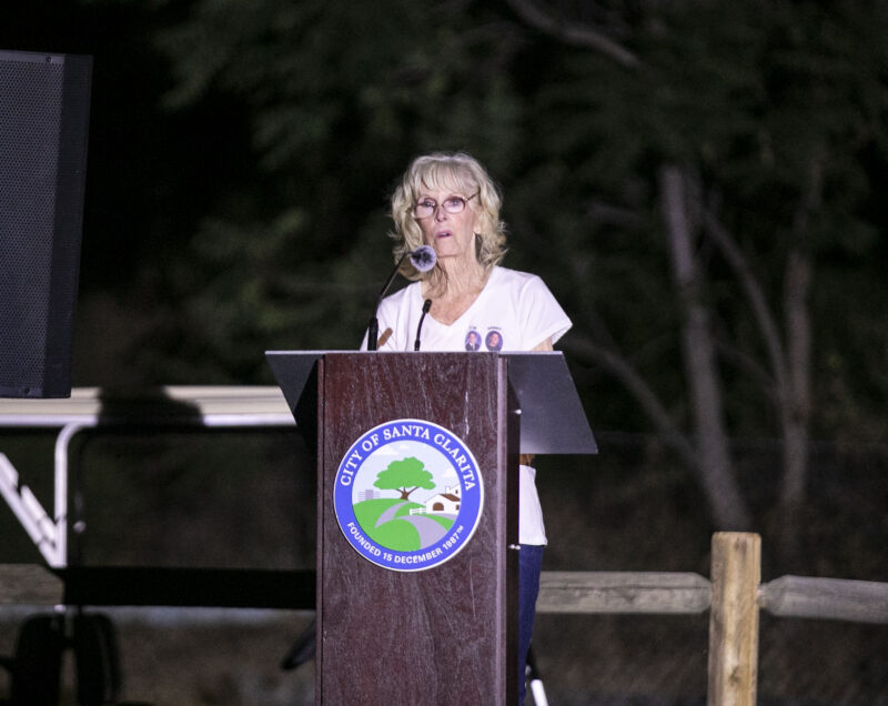 Alice Renolds, the Youth Grove committee member, reflects on the difficulty of losing her sons, Daniel and Timothy Renolds, 25 years ago during the Evening of Remembrance at Central Park on Wednesday, Aug. 27, 2025. Habeba Mostafa/ The Signal