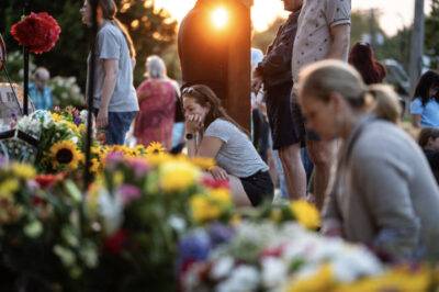 People sit in silence mourning two schoolchildren who were killed a day before during a shooting at Annunciation Catholic School in Minneapolis on Aug. 28, 2025. Photo by Madalina Kilroy