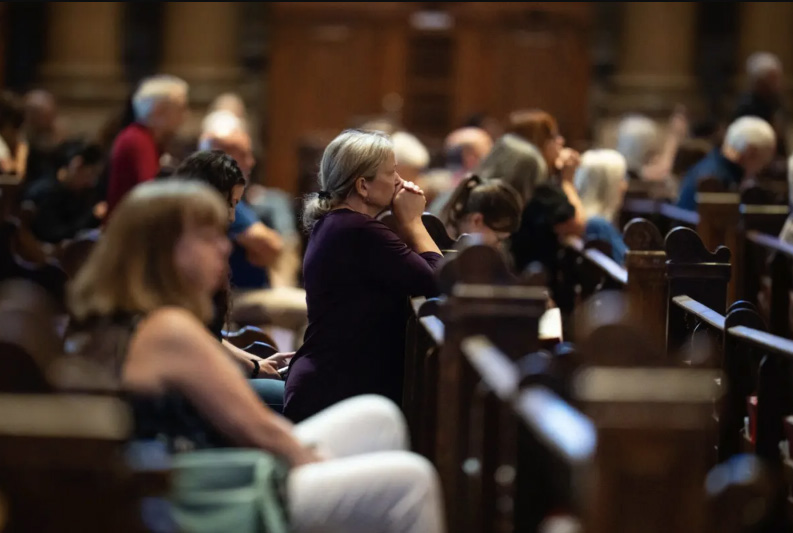 People pray at the Cathedral of Saint Paul, in the aftermath of the Annunciation Catholic School shooting, in Saint Paul, Minn., on Aug. 28, 2025. Photo by Madalina Kilroy.