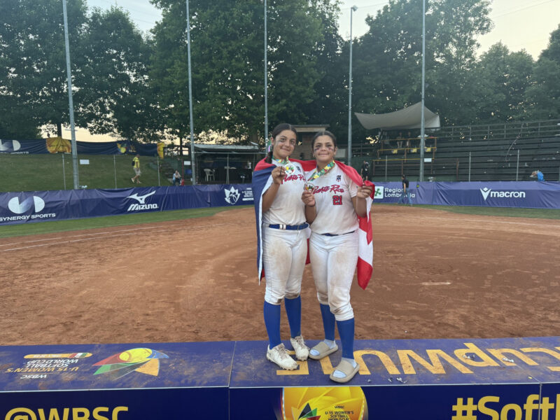 Naima Melendez (L) and Nylah Melendez (R) celebrate with their medals at The WBSC U-15 Women’s Softball World Cup in Italy. Photo Courtesy of Luis Melendez.