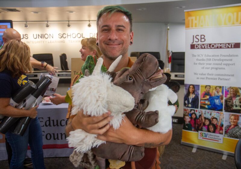 Bouquet Early Learning Academy teacher Brandon Holtzlaw with the puppets he was awarded by the SCV Education Foundation on Aug. 29, 2025. Katherine Quezada/The Signal