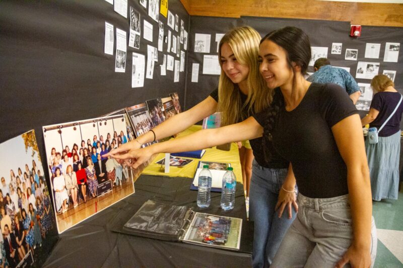 Deanna (back) and Jade Satorhelyi point out their grandmother Teri in a 1988-89 photo of Meadows Elementary during the 50th birthday celebration on Sept. 5, 2025. Katherine Quezada/The Signal