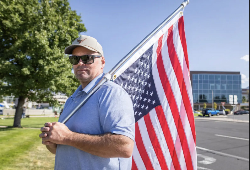 Supporter "Neal" waves an upside down American flag as a sign of a "nation in distress" one day after the fatal shooting of Charlie Kirk on the campus of Utah Valley University, in Orem, Utah, on Sep. 11, 2025. Photo by John Fredricks.