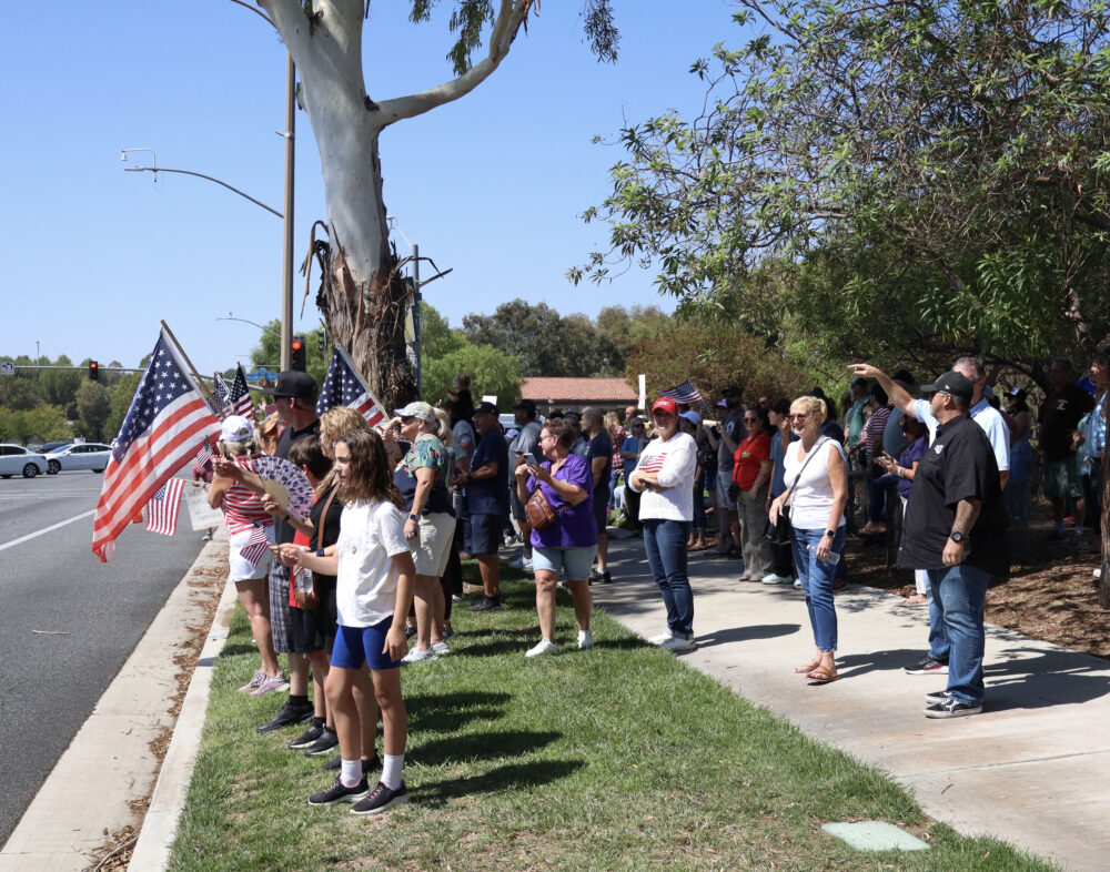 Attendees gather to remember Charlie Kirk at the intersection of McBean Parkway and Valencia Boulevard for a memorial after the assassination of Charlie Kirk, Sunday, Sept. 14, 2025. Kamryn Martell/The Signal