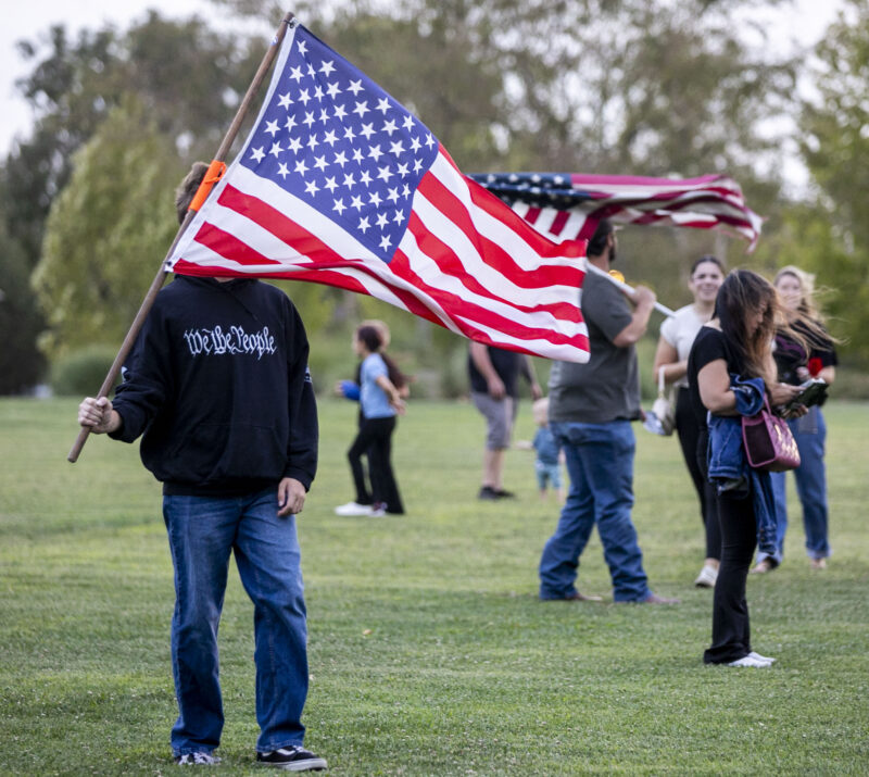 Attendees carried flags in support of Charlie Kirk during the Turning Point USA at Saugus High School Candlelight Vigil in Memory of Charlie Kirk at Marketplace Park in Valencia on Wednesday, Sept. 17, 2025. Habeba Mostafa/ The Signal