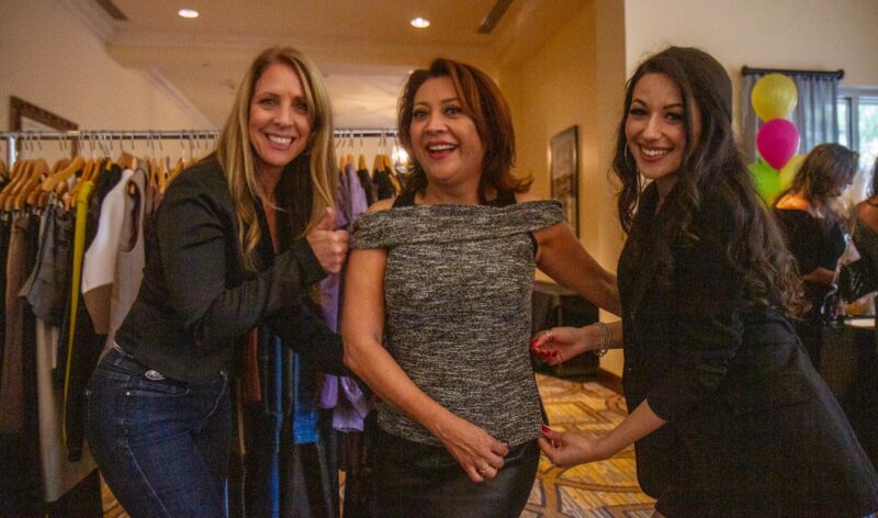 Councilwoman Patsy Ayala (center) tries on a top during the boutique segment of the 14th annual Fashion show hosted by Soroptimist of Greater Santa Clarita Valley at the Hyatt on Sept. 13, 2025. Katherine Quezada/The Signal