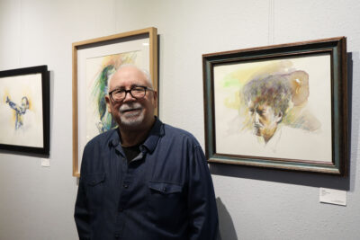 Featured artist Bob Hernandez poses with his art piece "Dylan" at the "Celebrating Life" art exhibit at The Main in Newhall, Calif., Thursday, Sept. 18, 2025. Kamryn Martell/The Signal