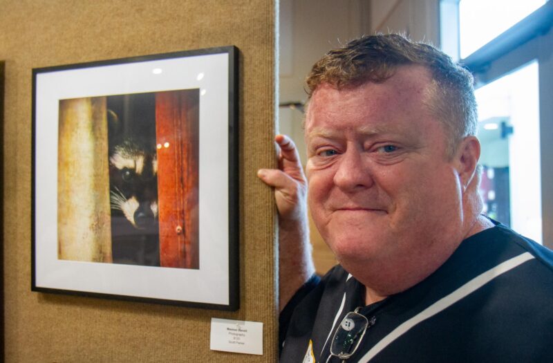 Photographer Scott Parker with an image he captured of a raccoon and submitted for the 35 annual Art Classic  hosted by the Santa Clarita Artists Association on Sept. 27, 2025 at The Centre. Katherine Quezada/The Signal