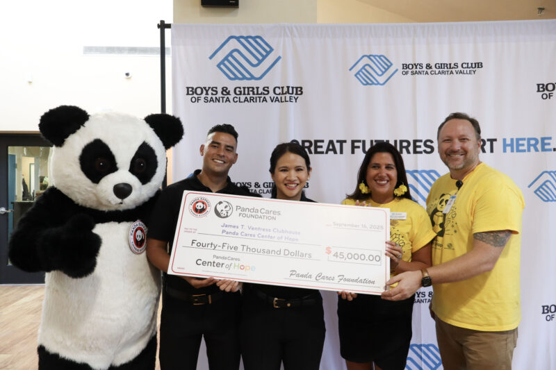 Panda Express members, Jenny Ketchepaw, board president of the Santa Clarita Valley Boys & Girls Club, and Matt Nelson, CEO of SCV Boys & Girls Club, smile with a check during the Panda Cares Foundation Center of Hope ceremony at the Santa Clarita Valley Boys & Girls Club - James T. Ventress Clubhouse in Newhall, Wednesday, Sept. 24, 2025. Kamryn Martell/The Signal