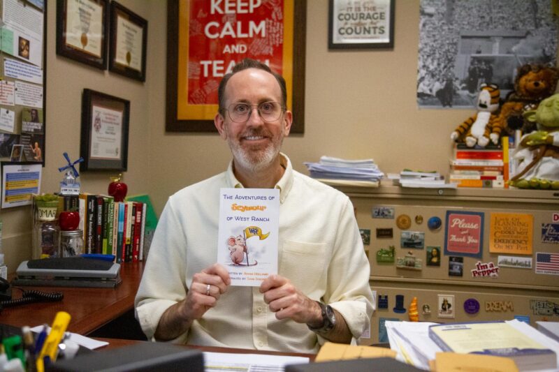 West Ranch High School teacher Adam Holland with his book “The Adventures of Seymour of West Ranch.” Katherine Quezada/The Signal