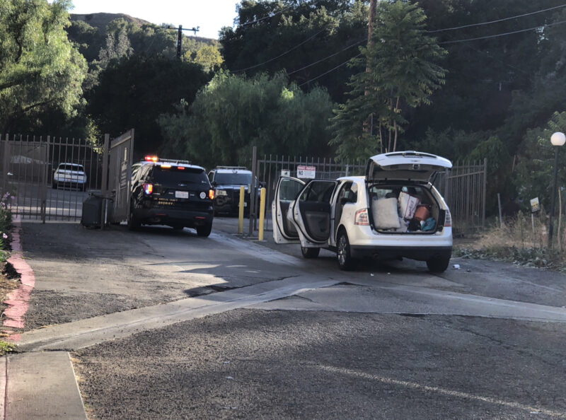 A suspect is at large after stealing a vehicle and leaving it in a driveway near an apartment complex at the intersection of Newhall Avenue and Valle Del Oro on Sunday afternoon. Courtesy photo of Oscar Sol.