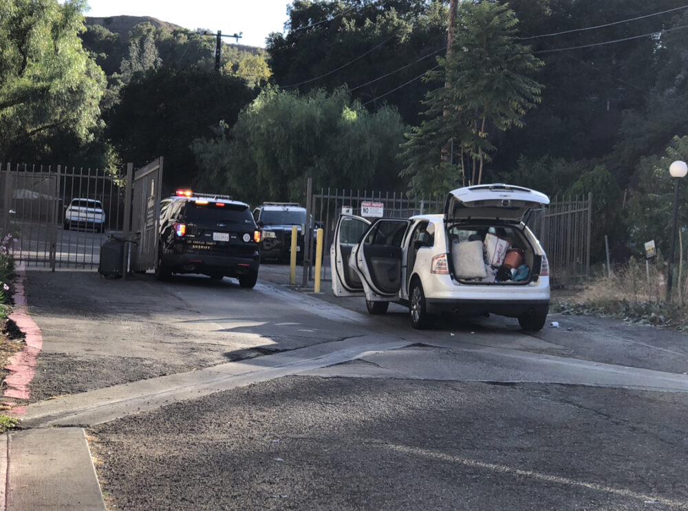A suspect is at large after stealing a vehicle and leaving it in a driveway near an apartment complex at the intersection of Newhall Avenue and Valle Del Oro on Sunday afternoon. Courtesy photo of Oscar Sol.