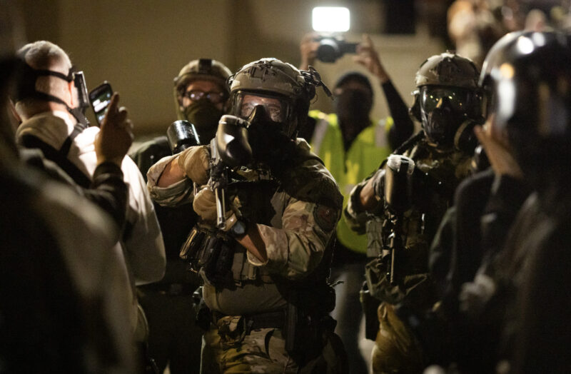 A federal agent prepares to fire pepper ball rounds at protesters in front of Immigration and Customs Enforcement offices in Portland, Ore., on Oct. 4, 2025. Photo by John Fredricks.