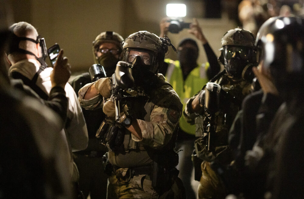 A federal agent prepares to fire pepper ball rounds at protesters in front of Immigration and Customs Enforcement offices in Portland, Ore., on Oct. 4, 2025. Photo by John Fredricks.