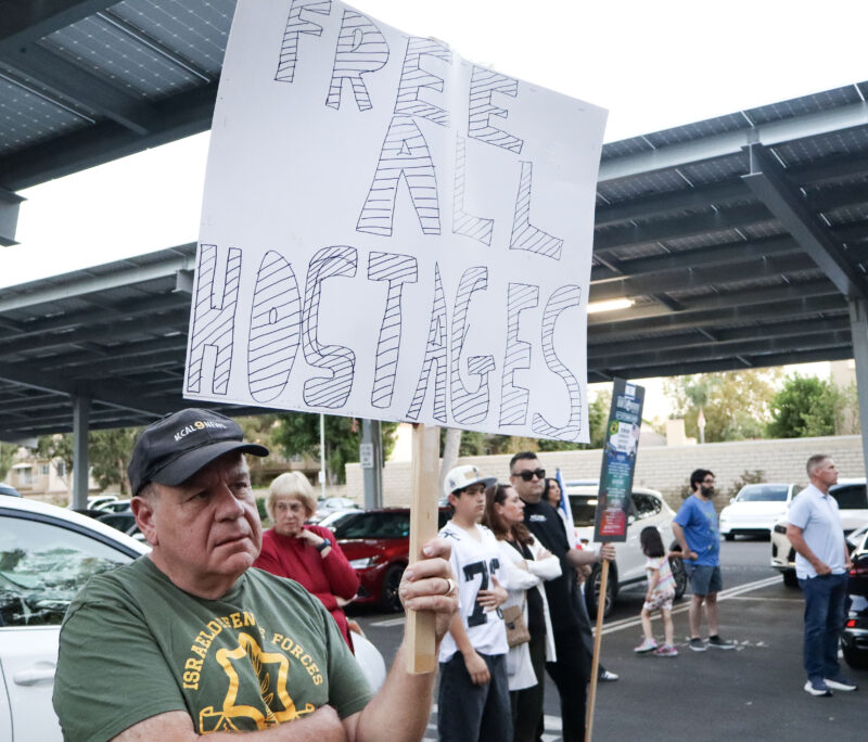 Manny F. holds a sign up at the "October 7th" memorial at the City of Santa Clarita City Hall, Sunday, Oct. 5, 2025. Kamryn Martell/The Signal