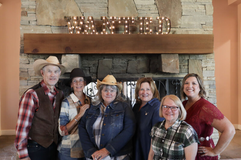 The Titania K9 Fund Committee pose in front of the "Wanted" sign at the Titania K9 Fund "Wanted: Wild West" Gala at the Sand Canyon Country Club in Canyon Country, Sunday, Oct. 5, 2025. Kamryn Martell/The Signal