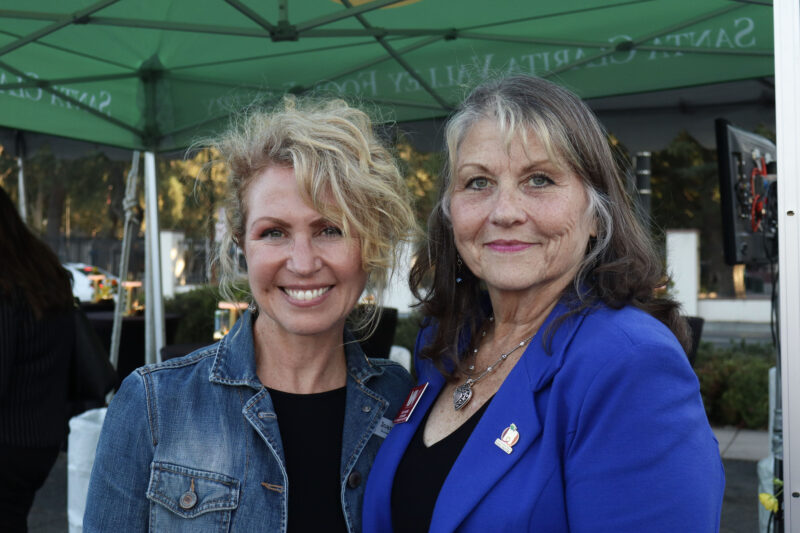 Joanne Ainsworth (L), executive director for the Santa Clarita Valley Food Pantry, and Kathy Norris (R), CEO for Valley Industry Association, smile for the camera at the Valley Industry Association mixer for the SCV Food Pantry's 40th anniversary at the SCV Food Pantry in Newhall, Calif., Thursday, Oct. 2, 2025. Kamryn Martell/The Signal