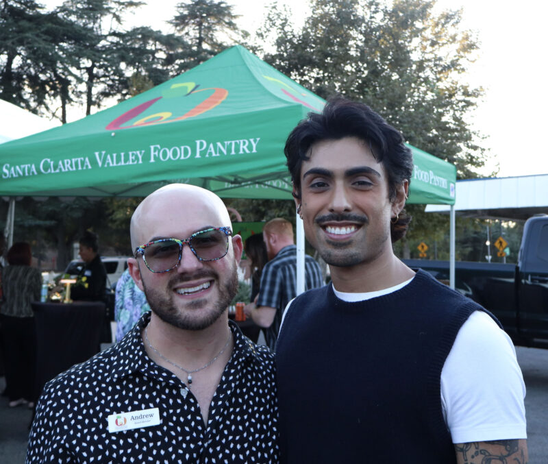Andrew Taban (L), vice president of the board of directors at the Santa Clarita Valley Food Pantry, and Jesse De La O (R), an attendee, pose for the camera at the Valley Industry Association mixer for the SCV Food Pantry's 40th anniversary at the SCV Food Pantry in Newhall, Calif., Thursday, Oct. 2, 2025. Kamryn Martell/The Signal