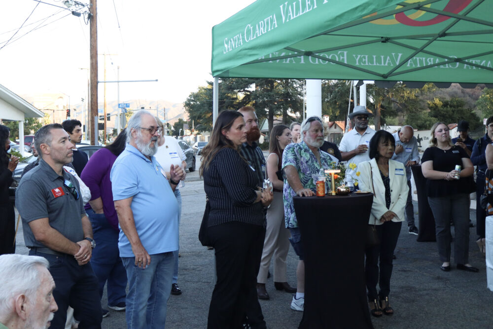 Attendees listen to the speeches at the Valley Industry Association mixer for the Santa Clarita Valley Food Pantry's 40th anniversary at the SCV Food Pantry in Newhall, Calif., Thursday, Oct. 2, 2025. Kamryn Martell/The Signal