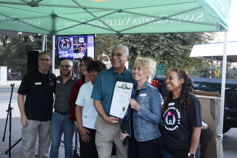 Bill Miranda (blue shirt, C), mayor of Santa Clarita Valley, poses with the SCV Food Pantry board of directors at the Valley Industry Association mixer for the SCV Food Pantry's 40th anniversary at the SCV Food Pantry in Newhall, Calif., Thursday, Oct. 2, 2025. Kamryn Martell/The Signal