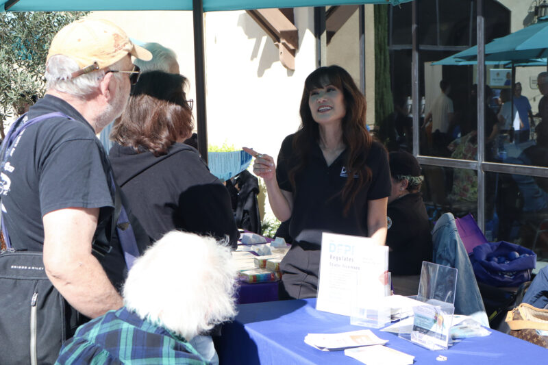 Sally Westlake (R, black shirt), targeted outreach specialist of the Department of Financial Protection and Innovation, speaks with attendees about identity fraud at Assemblywoman Pilar Schiavo's third annual Senior Resource Fair at the Santa Clarita Valley Senior Center at Bella Vida, Thursday, Oct. 9, 2025. Kamryn Martell/The Signal