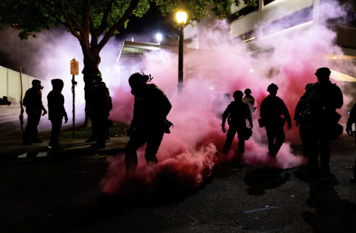 Federal officers deploy smoke grenades to deter protesters in front of Immigration and Customs Enforcement offices in Portland, Ore., on Oct. 5, 2025. Photo by John Fredricks.