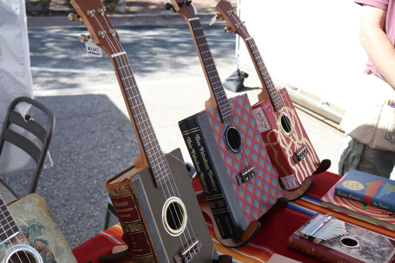 JJ Pomegranate's bookuleles sit on display at the Old Town Newhall Fine Art Festival on Main Street in Newhall, Calif., Sunday, Oct. 12, 2025. Kamryn Martell/The Signal
