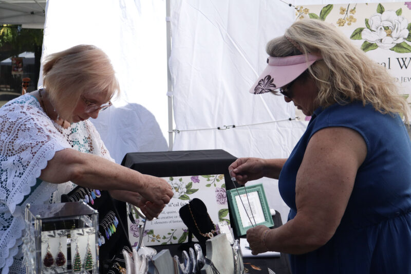 Charlotte Mullich (L) and Jennie Stott (R) look at jewelry at the Old Town Newhall Fine Art Festival on Main Street in Newhall, Calif., Sunday, Oct. 12, 2025. Kamryn Martell/The Signal