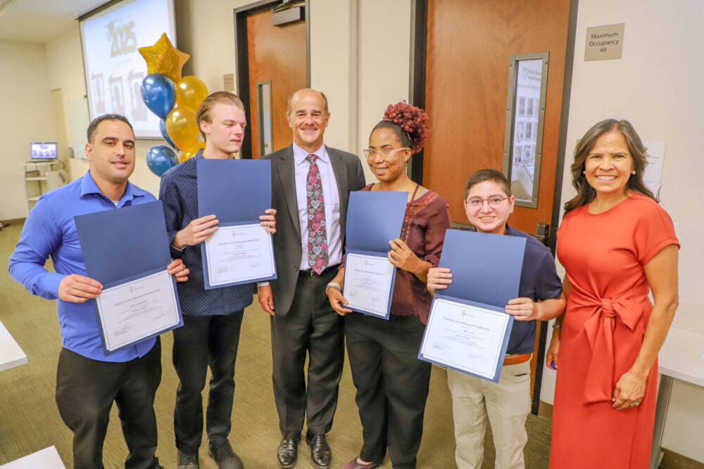 Kevin A. Klockenga (center), president and CEO of Henry Mayo Newhall Hospital, and April Garcia (far right), manager of volunteer services, congratulate the hospital’s PathPoint internship graduates. Courtesy photo.