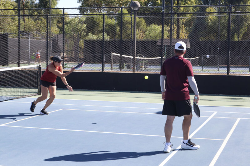 Bonnie Mahler (L) and Steve Rusk (R) try to hit the ball back to the other side of the court at The Michael Hoefflin Foundation “Paddle for the Battle” pickleball fundraiser at The Paseo Club in Valencia, Calif., Sunday, Oct. 12, 2025. Kamryn Martell/The Signal
