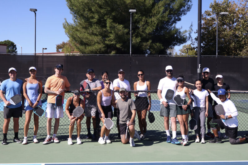 Players pose for a photo at The Michael Hoefflin Foundation “Paddle for the Battle” pickleball fundraiser at The Paseo Club in Valencia, Calif., Sunday, Oct. 12, 2025. Kamryn Martell/The Signal