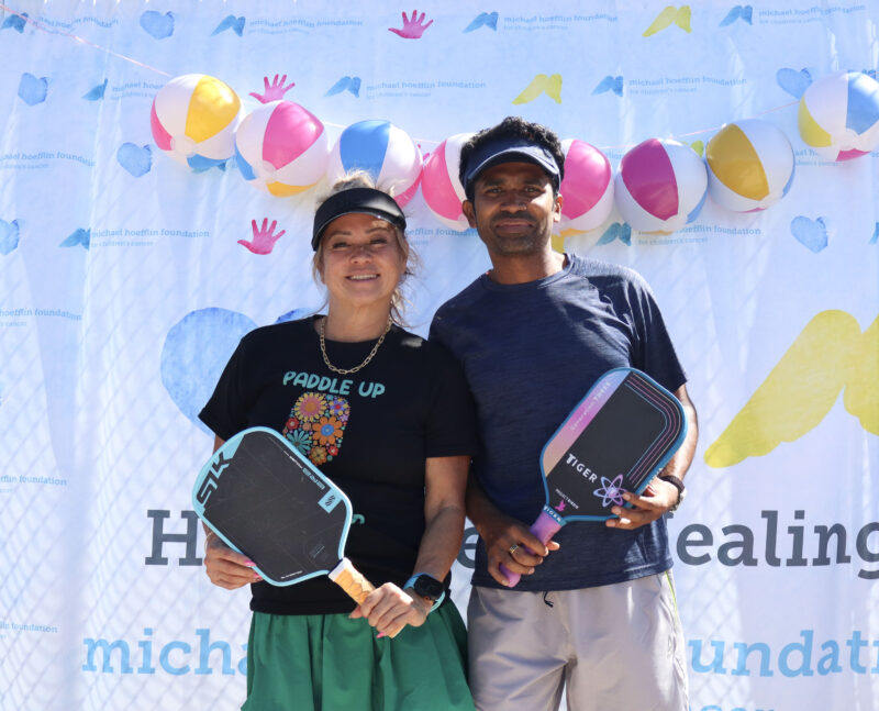 Jacqueline Zinder (L) and Vishnu Ananthula (R) smile for the camera at The Michael Hoefflin Foundation “Paddle for the Battle” pickleball fundraiser at The Paseo Club in Valencia, Calif., Sunday, Oct. 12, 2025. Kamryn Martell/The Signal