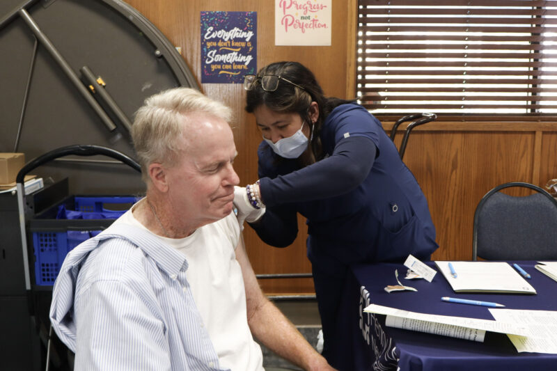 Jeff Boyd gets his flu shot by Josan Leoncio, Henry Mayo Newhall Hospital nurse, at the Our Lady of Perpetual Help Health & Wellness Fair at OLPH in Newhall, Calif., Sunday, Oct. 19, 2025. Kamryn Martell/The Signal