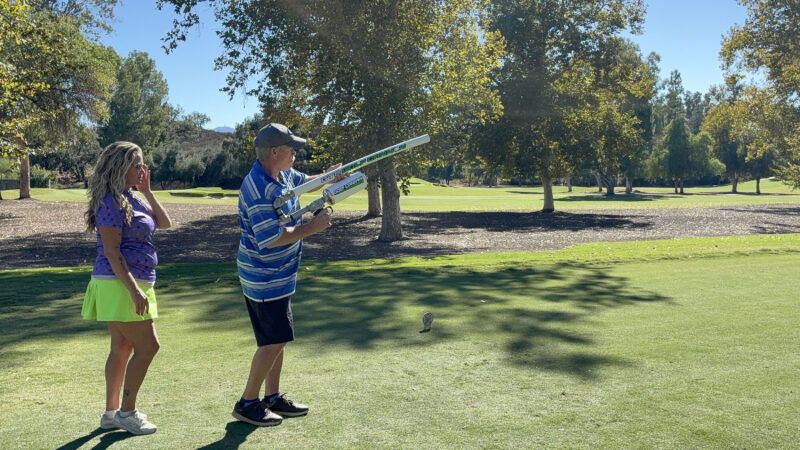 Traci McNeil (L) assists Jeffrey Rich (R) with the golf ball cannon at the College of the Canyons' "Swing for Students' Success" annual golf tournament at Valencia Country Club in Valencia, Calif., Monday, Oct. 20, 2025. Kamryn Martell/The Signal