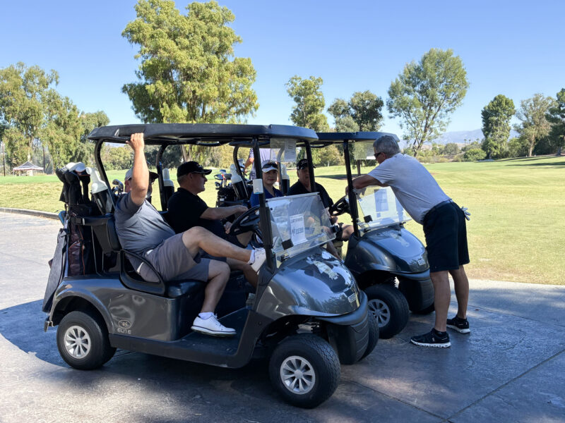 Attendees hang out in the golf carts before the next hole at the College of the Canyons' "Swing for Students' Success" annual golf tournament at Valencia Country Club in Valencia, Calif., Monday, Oct. 20, 2025. Kamryn Martell/The Signal