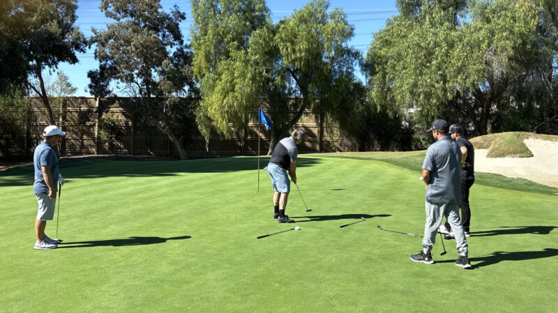 Attendees take turns at a putting hole at the College of the Canyons' "Swing for Students' Success" annual golf tournament at Valencia Country Club in Valencia, Calif., Monday, Oct. 20, 2025. Kamryn Martell/The Signal