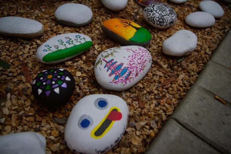 “Make a Difference Day” volunteers paint rocks to place as decorative pieces for the ARTree Community Arts Center on Oct. 25, 2025 in Newhall, Calif. Katherine Quezada/The Signal