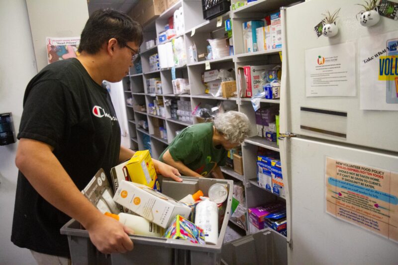 SCV Food Pantry volunteers Yasmine Razack (back) and Ethan Balgemino (front) organize resources provided to the organization for those in need during “Make a Difference Day” on Oct. 25, 2025 in Newhall, Calif. Katherine Quezada/The Signal