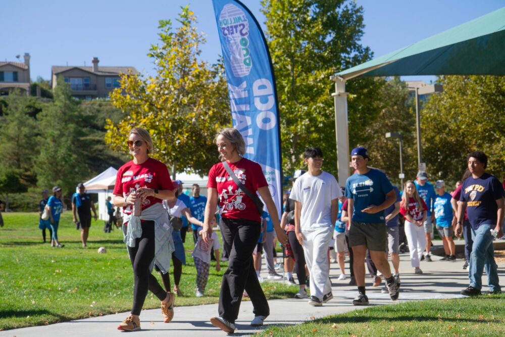 OCD Walk co-chairs Annie Barker (left) and Kjersti Helberg lead 150 people to begin the OCD Walk at Fair Oaks Part on Oct. 18, 2025. Katherine Quezada/The Signal