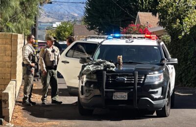 A stolen vehicle suspect is taken into custody after a brief containment in the Newhall area on Thursday. Katherine Quezada/The Signal