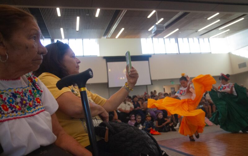 Maria Inez Sanchez (left) and her daughter Marcela Lagunas watch the Folklorico performers during the  Dia De Muertos celebration at the Canyon Country Community Center in Canyon Country on Oct. 25, 2025. Katherine Quezada/The Signal
