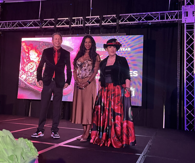 VIA Chairwoman Selina Thomas (center), and VIA Bash Chair Hillary Broadwater (right) join Fred Arnold, owner of 360 Executive Suites, as he celebrates after winning the VIA Business of the Year Award. Photo by Jeremiah Yonemura/For The Signal.