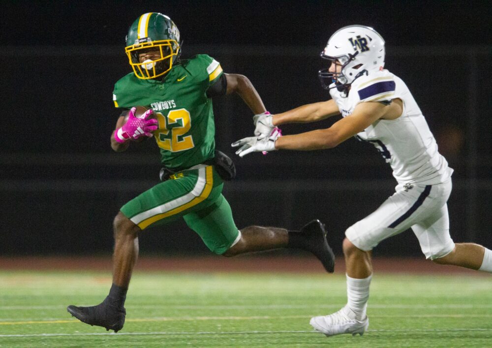 Canyon running back Keyshawn Wooten (22) escapes West Ranch defensive back Jeremiah Webster-Zaday during Friday’s game on Oct. 31, 2025 at Canyon. Katherine Quezada/The Signal