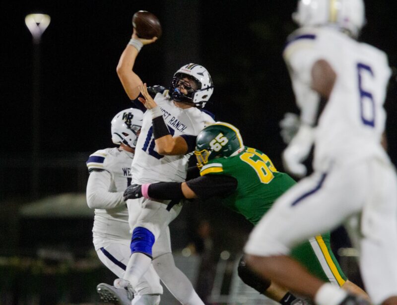 West Ranch quarterback Blake Johnson (18) struggles to pass the ball as Canyon makes contact  during Friday’s game on Oct. 31, 2025 at Canyon. Katherine Quezada/The Signal
