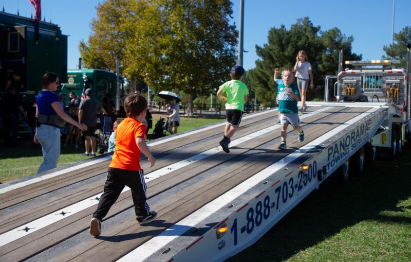 Children run across a flatbed tow truck during the fourth annual Touch-a-Truck hosted by the Santa Clarita Valley Education Foundation at Central Park in Saugus on Nov. 1, 2025. Katherine Quezada/The Signal