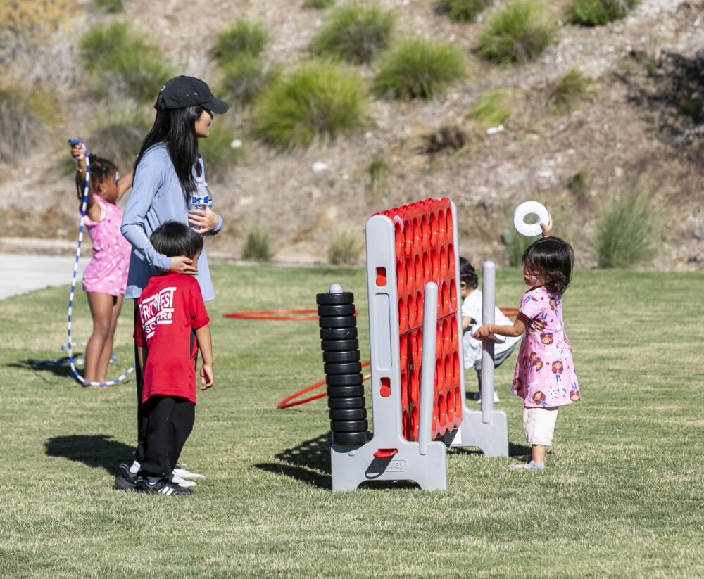Children of all ages enjoyed activities, such as Connect 4, during the opening of Riparian Park in Valencia by FivePoint on Saturday, Nov. 1, 2025. Habeba Mostafa/ The Signal