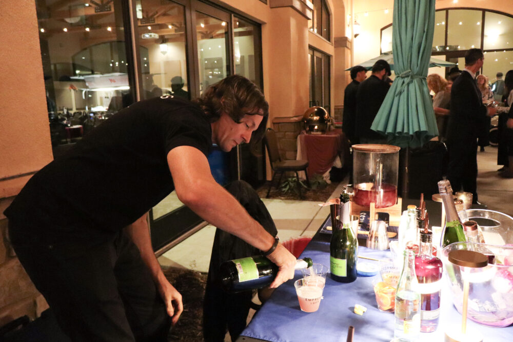 Damien Hartwell pours some drinks at the Empress Gin booth at the WiSH Foundation's "Wine Under the Roof" event at the Santa Clarita Valley Senior Center at Bella Vida in Canyon Country, Calif., Thursday, Nov. 6, 2025. Kamryn Martell/The Signal