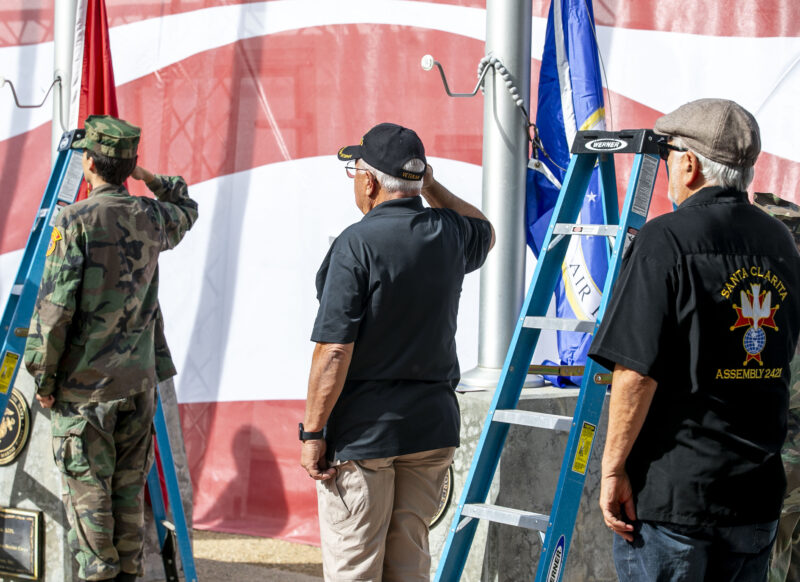 Knights of Columbus Santa Clarita Assembly, Vietnam Veterans of America, Chapter 355, and Santa Clarita Valley Young Marines change the flags during the 19th annual Santa Clarita Veterans Day Ceremony at Veterans Historical Plaza on Tuesday, Nov. 11, 2025. Habeba Mostafa/ The Signal